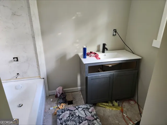a utility room with sink dryer and washer