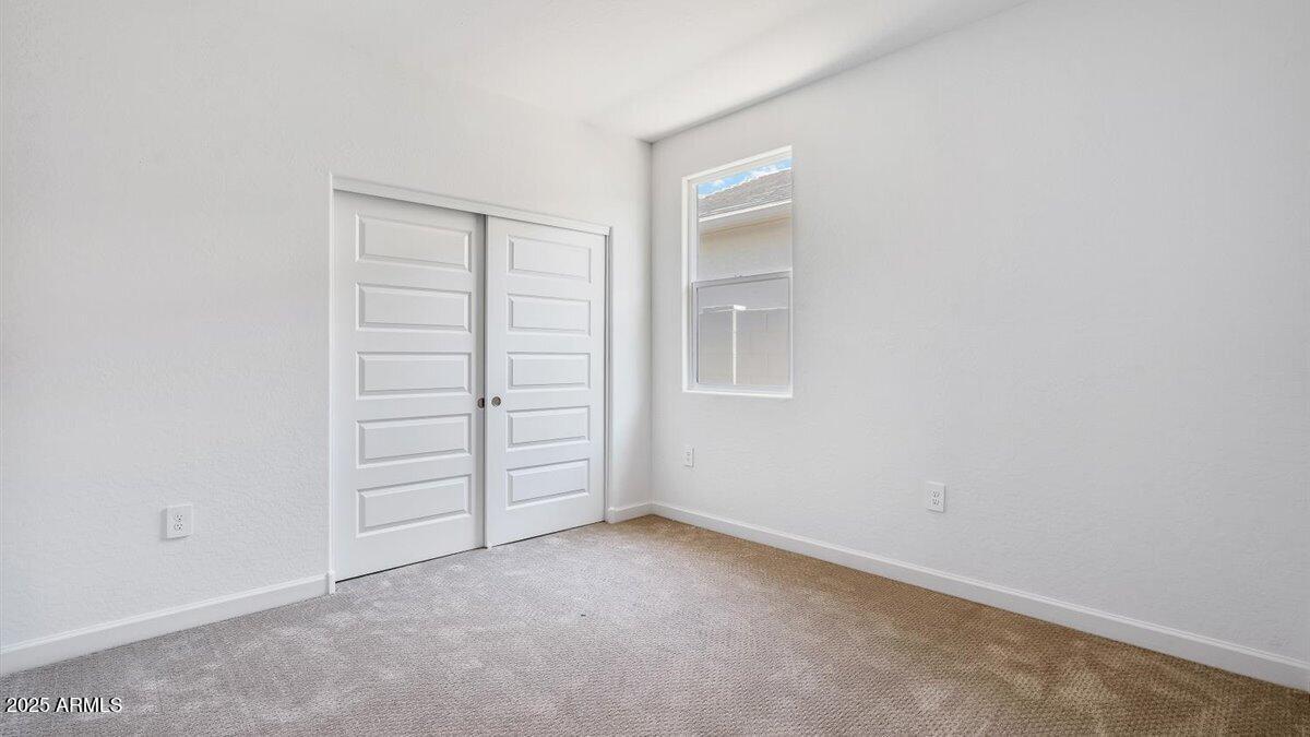 2323 West Solstice Avenue Apache Junction, AZ 85120 - Photo 17 of 24 an empty room with closet