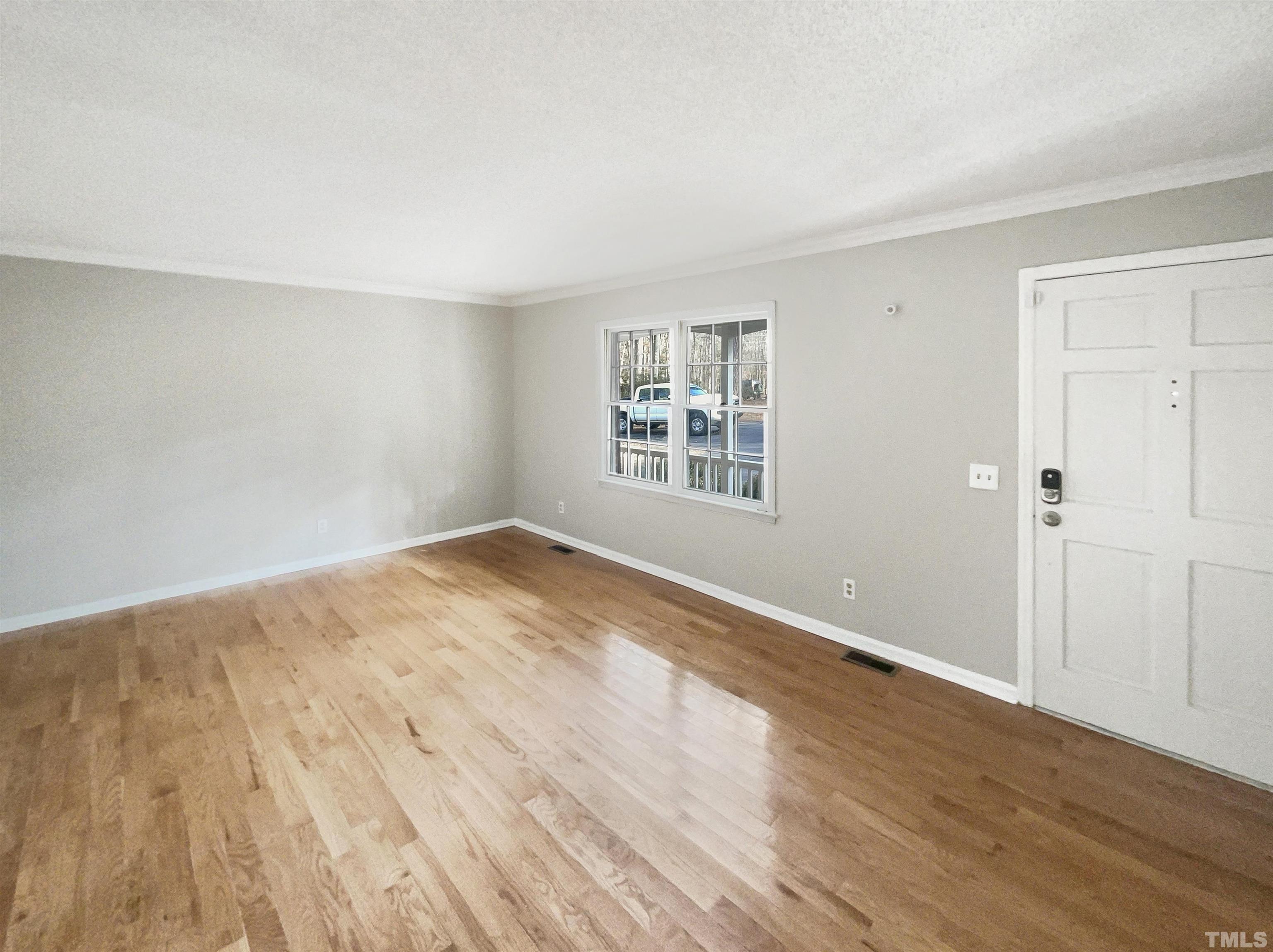 3216 Manor Ridge Drive Raleigh, NC 27603 - Photo 20 of 22 an empty room with wooden floor and windows