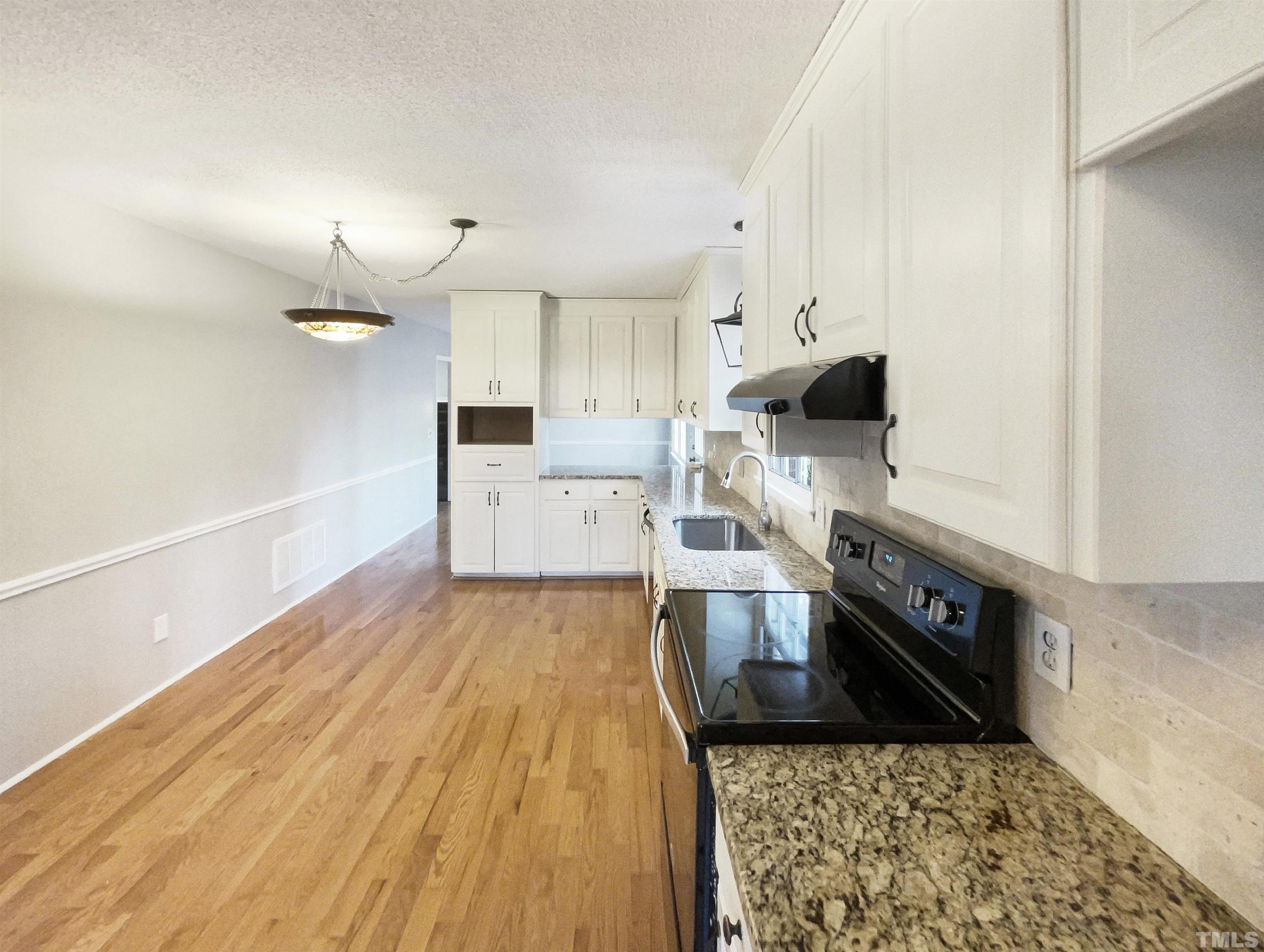 3216 Manor Ridge Drive Raleigh, NC 27603 - Photo 4 of 22 a large kitchen with stainless steel appliances granite countertop a granite counter tops and a stove