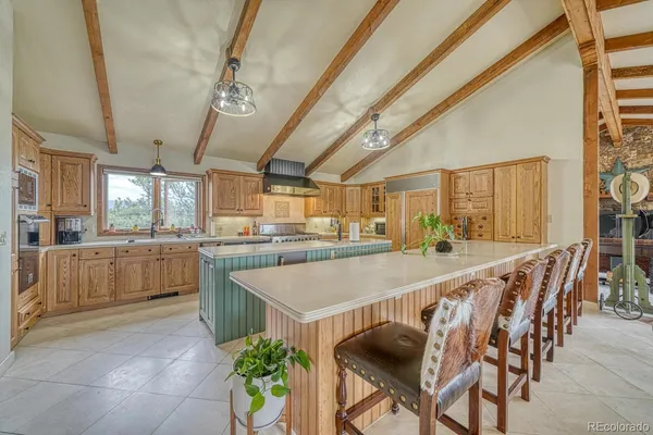 a large kitchen with a table and chairs