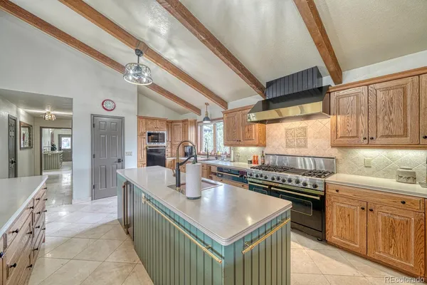 a kitchen with a sink a counter top space and stainless steel appliances
