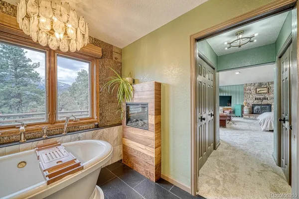 a bathroom with a tub a sink and a mirror