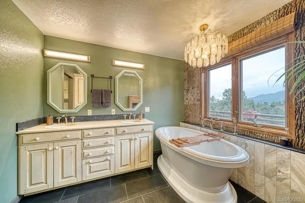 a bathroom with a double vanity sink a toilet a mirror and shower