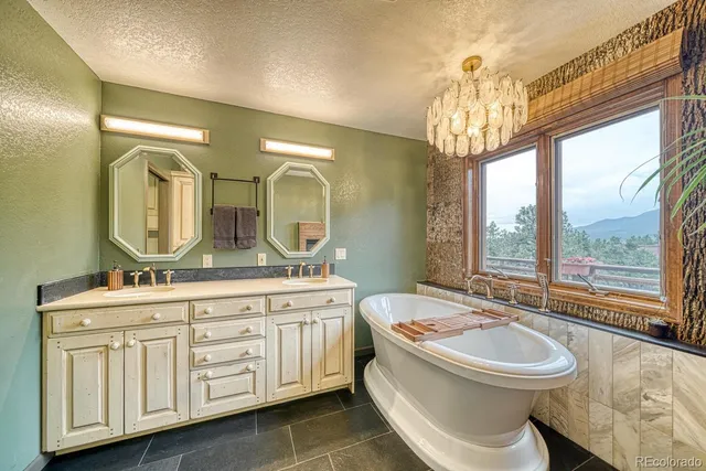 a bathroom with a double vanity sink a toilet a mirror and shower