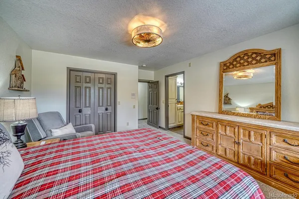 a bedroom with bed and a chandelier