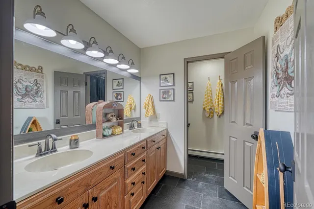 a bathroom with double vanity sink and a mirror