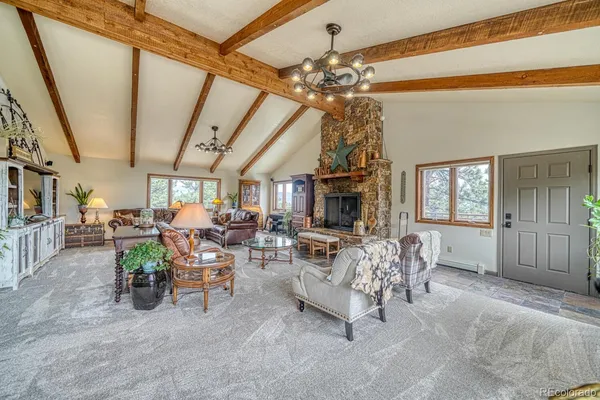 a living room with lots of furniture and a chandelier