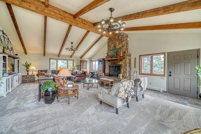 a living room with lots of furniture and a chandelier