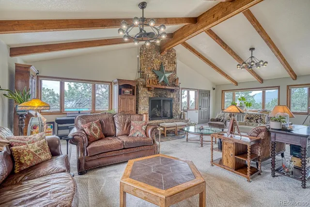 a living room with furniture a chandelier and a chandelier