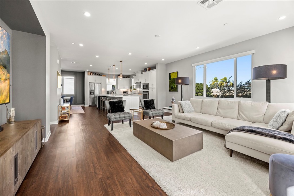 147 Schick Irvine, CA 92614 - Photo 13 of 35 a living room with furniture kitchen view and a wooden floor