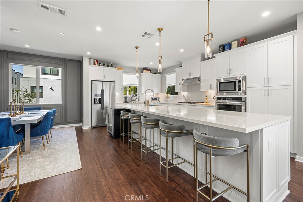 147 Schick Irvine, CA 92614 - Photo 15 of 35 a kitchen with stainless steel appliances a dining table chairs refrigerator and sink