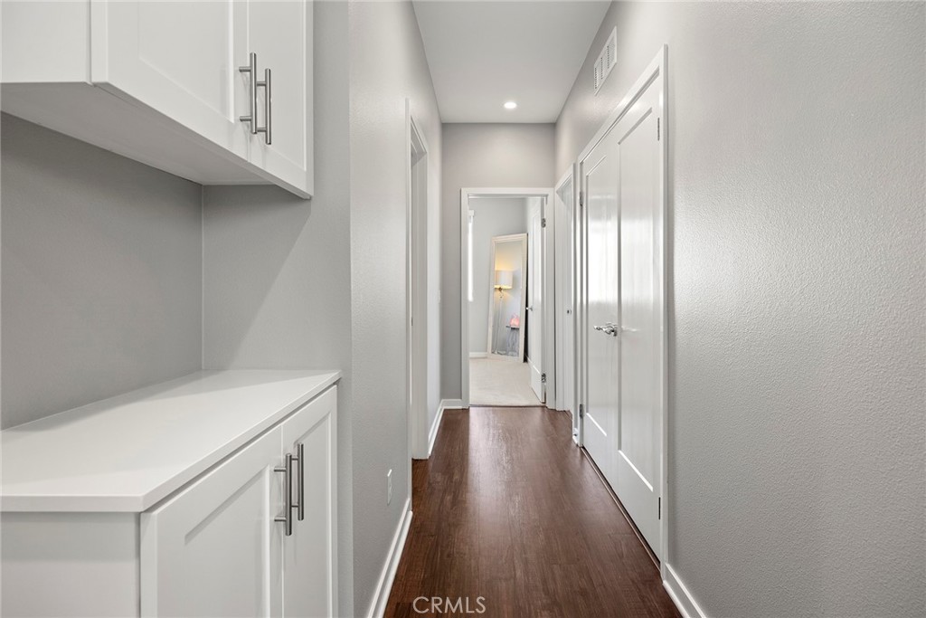 147 Schick Irvine, CA 92614 - Photo 23 of 35 a view of a hallway with wooden floor