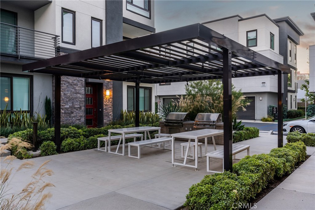 147 Schick Irvine, CA 92614 - Photo 34 of 35 a view of a patio with table and chairs potted plants and floor to ceiling window and potted plants
