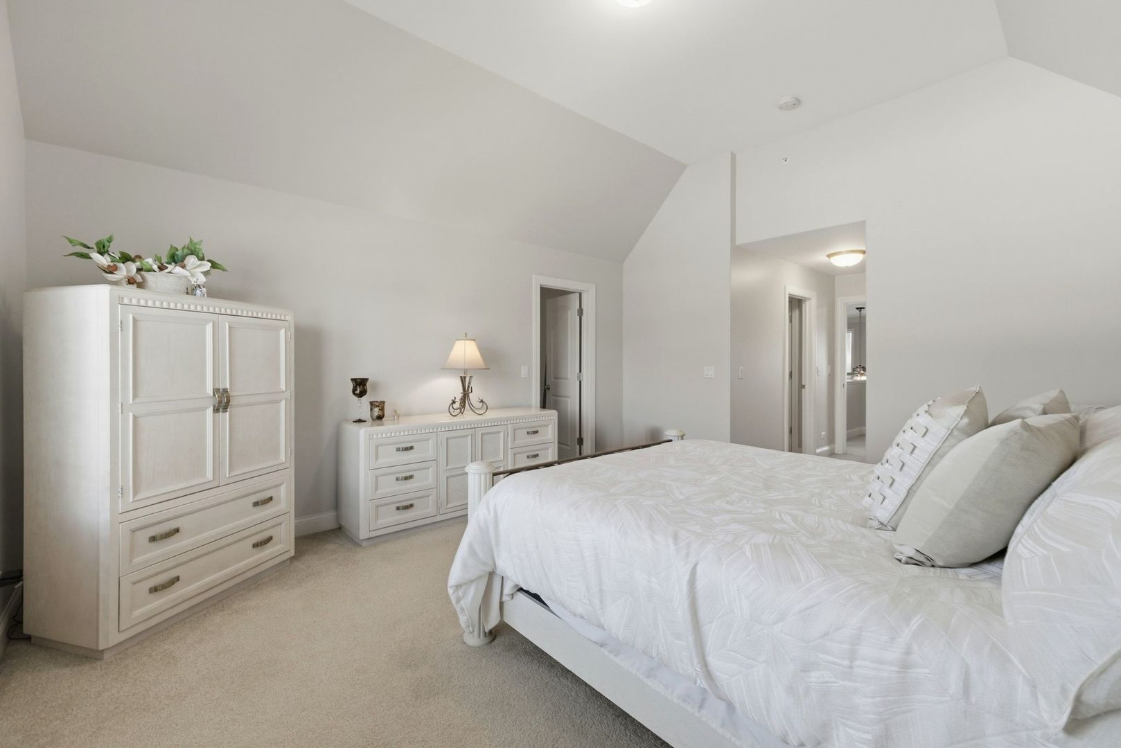 317 Nicole Way Itasca, IL 60143 - Photo 16 of 36 a spacious bedroom with a bed and a chandelier