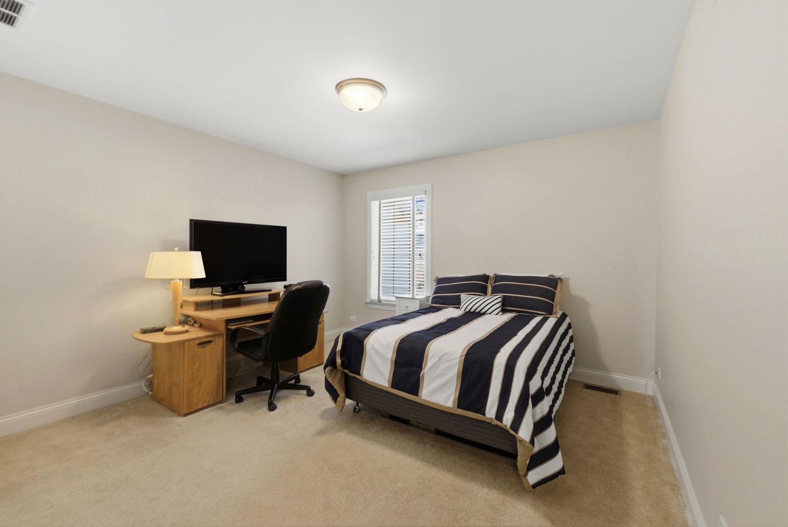 317 Nicole Way Itasca, IL 60143 - Photo 22 of 36 a bed room with a bed and television