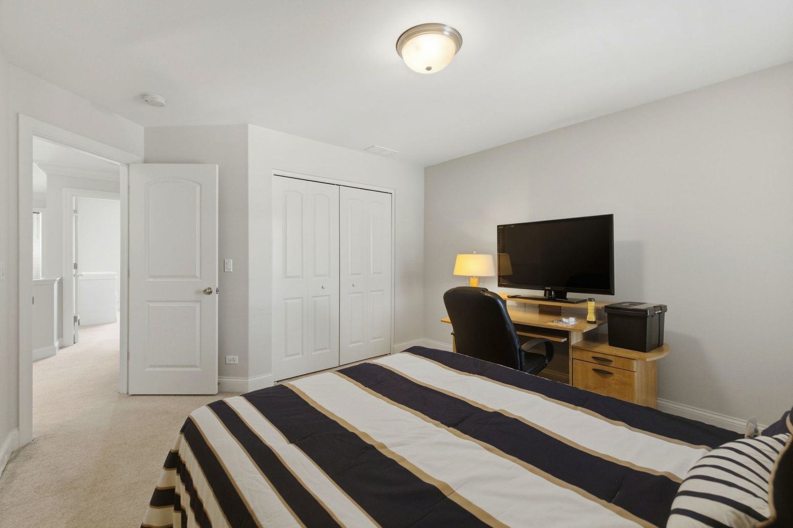 317 Nicole Way Itasca, IL 60143 - Photo 23 of 36 a bedroom with a bed and a flat screen tv