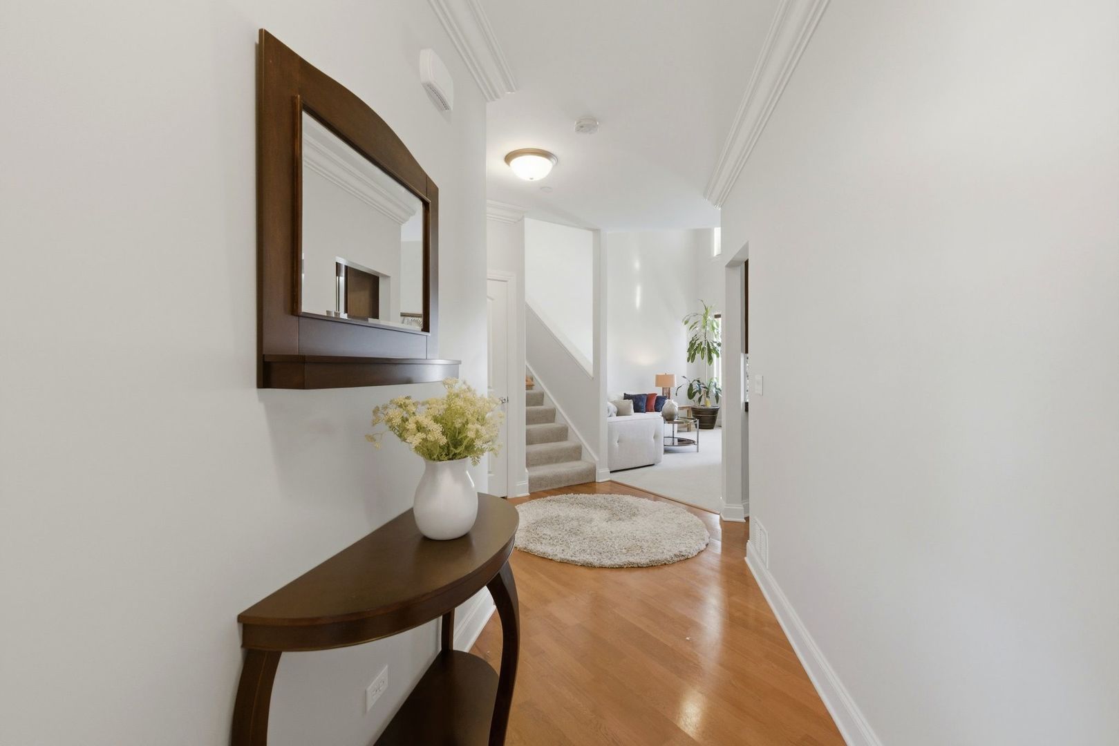 317 Nicole Way Itasca, IL 60143 - Photo 3 of 36 a view of a hallway with furniture and wooden floor
