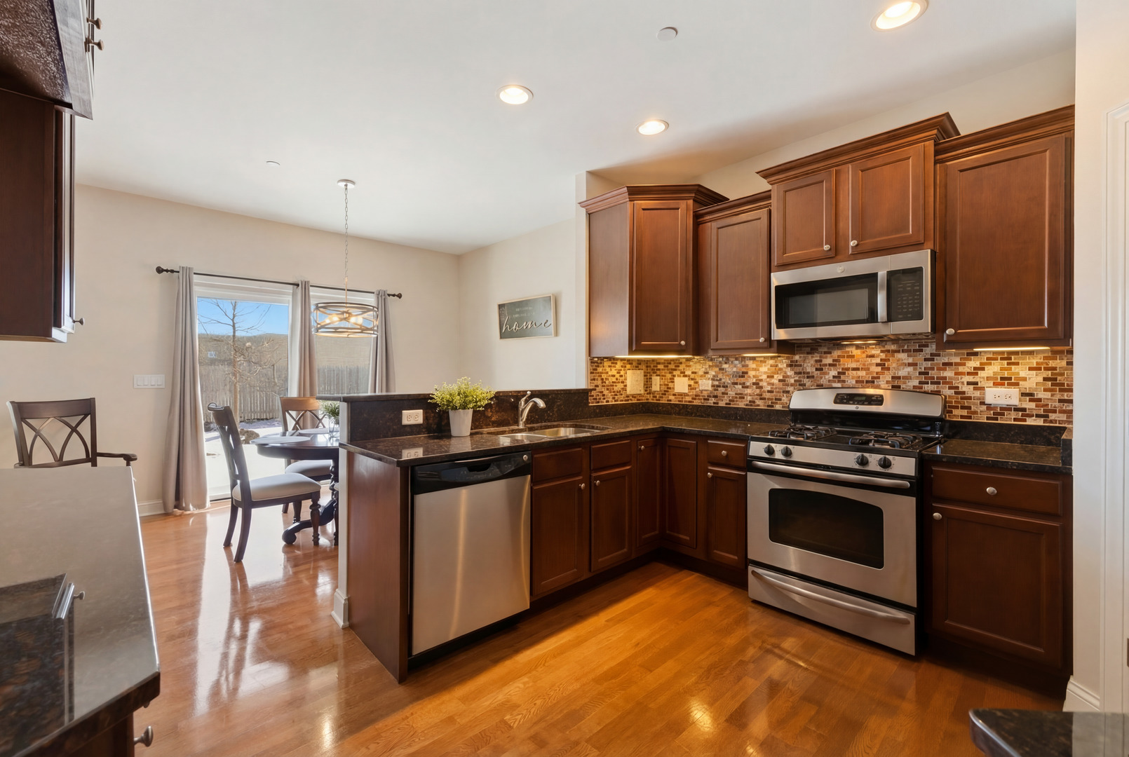 317 Nicole Way Itasca, IL 60143 - Photo 8 of 36 a kitchen with stainless steel appliances kitchen island granite countertop a stove and a sink