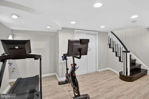 a view of a livingroom with wooden floor and furniture