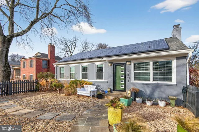 a front view of a house with barbeque grill and couches chairs