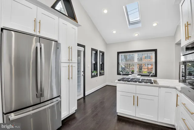 a kitchen with stainless steel appliances a refrigerator and a sink