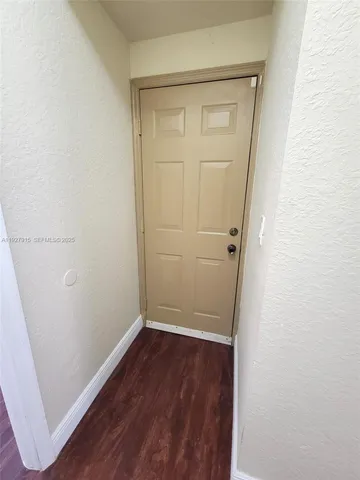 an empty room with wooden door
