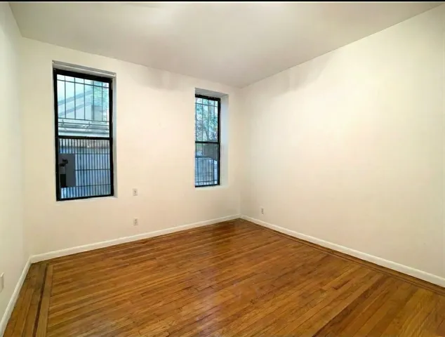 a bedroom with a bed and a chair with potted plants