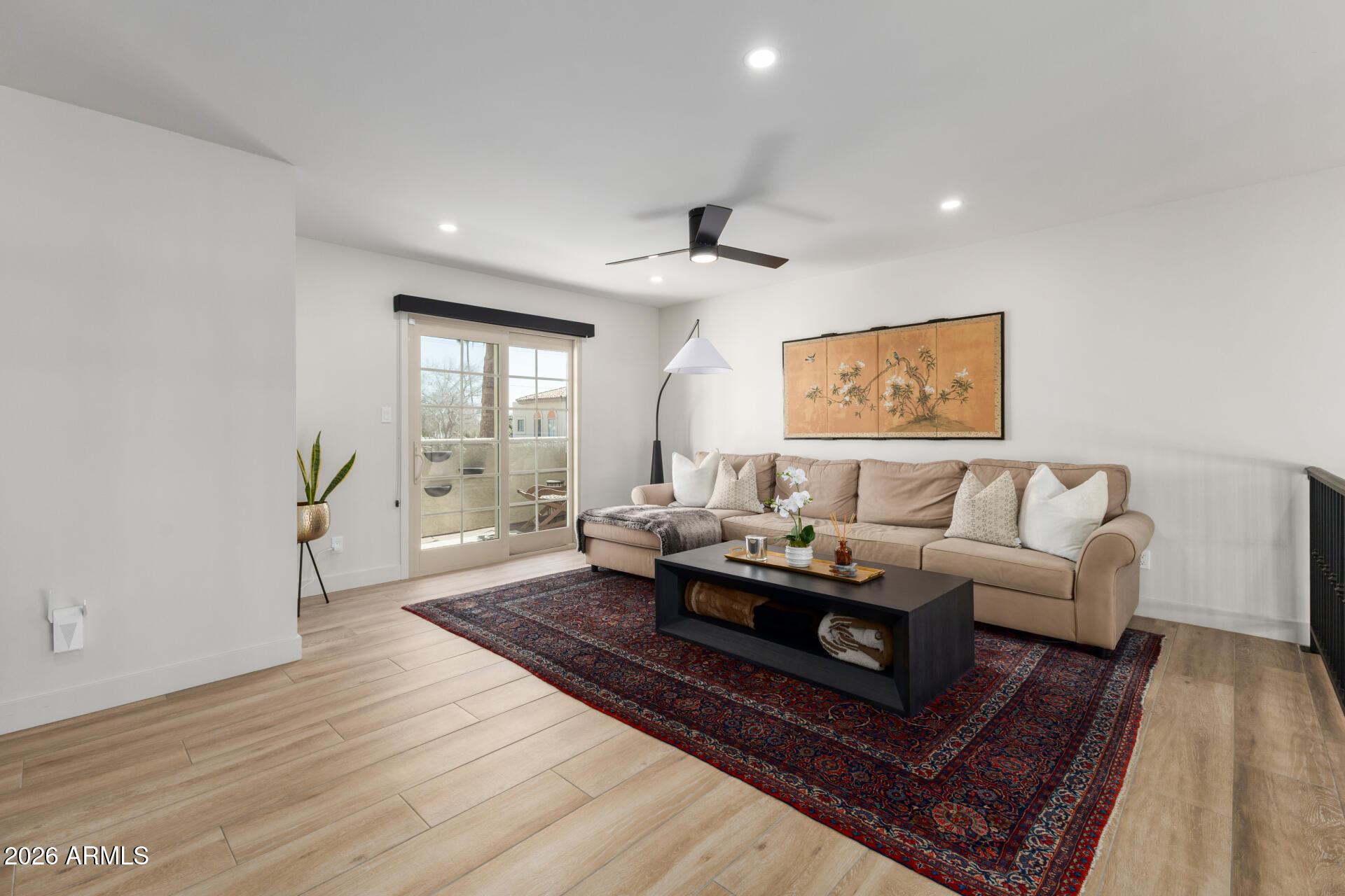 5812 North 12th Street, Unit 34 Phoenix, AZ 85014 - Photo 14 of 39 a living room with furniture and a wooden floor