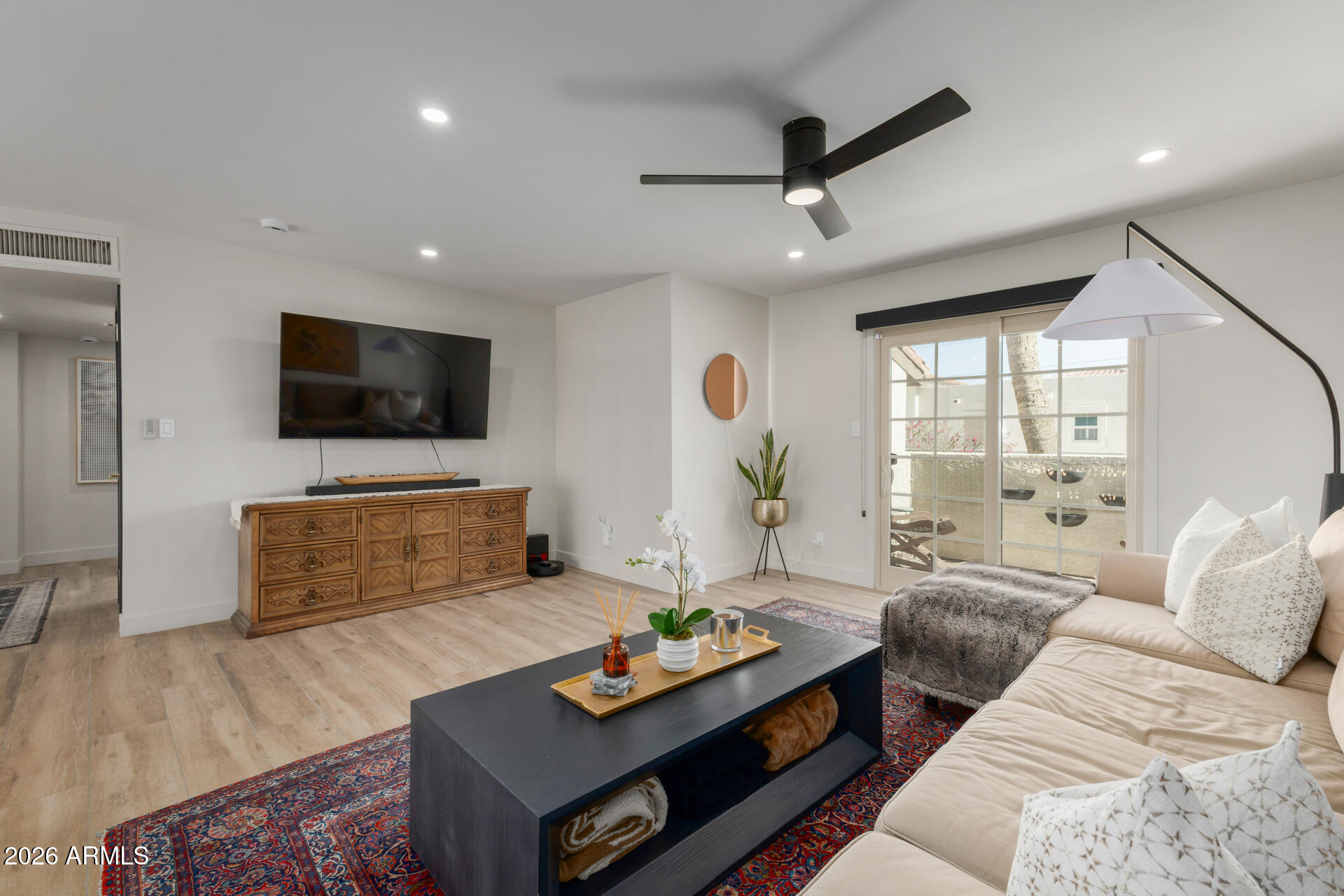 5812 North 12th Street, Unit 34 Phoenix, AZ 85014 - Photo 15 of 39 a living room with furniture and a flat screen tv