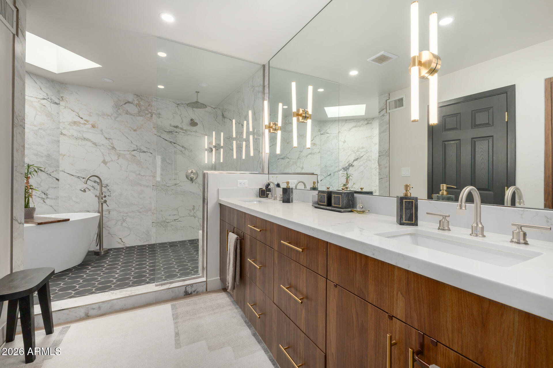 5812 North 12th Street, Unit 34 Phoenix, AZ 85014 - Photo 23 of 39 a bathroom with a double vanity sink a toilet a mirror and shower