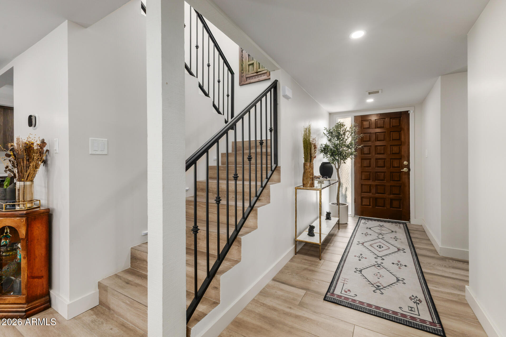 5812 North 12th Street, Unit 34 Phoenix, AZ 85014 - Photo 4 of 39 a view of hallway with stairs and wooden floor