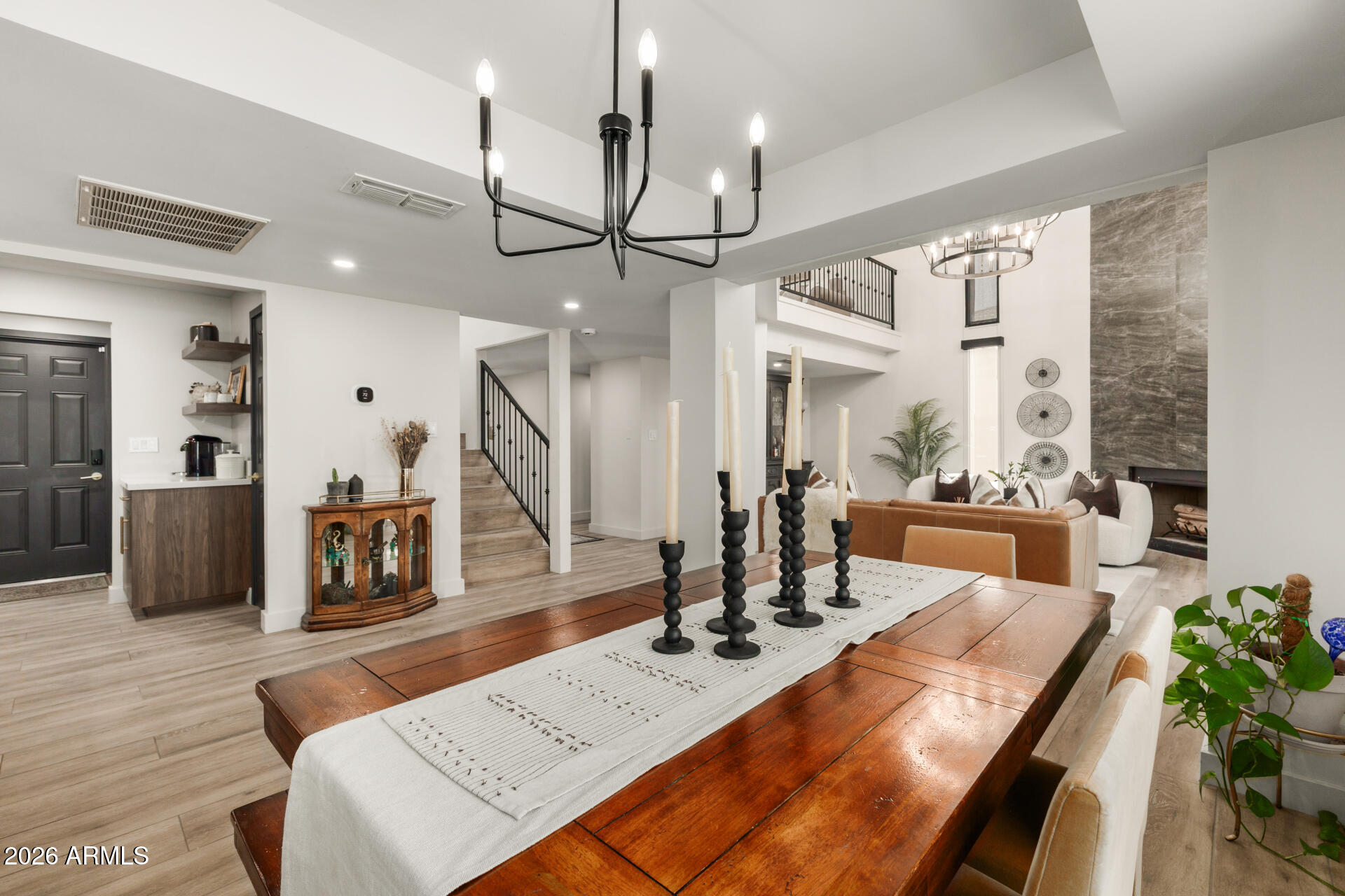 5812 North 12th Street, Unit 34 Phoenix, AZ 85014 - Photo 8 of 39 a living room with furniture a wooden floor and a chandelier