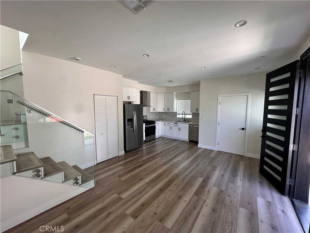 9585 Woodale Avenue Arleta, CA 91331 - Photo 3 of 21 a kitchen with stainless steel appliances a refrigerator and a sink