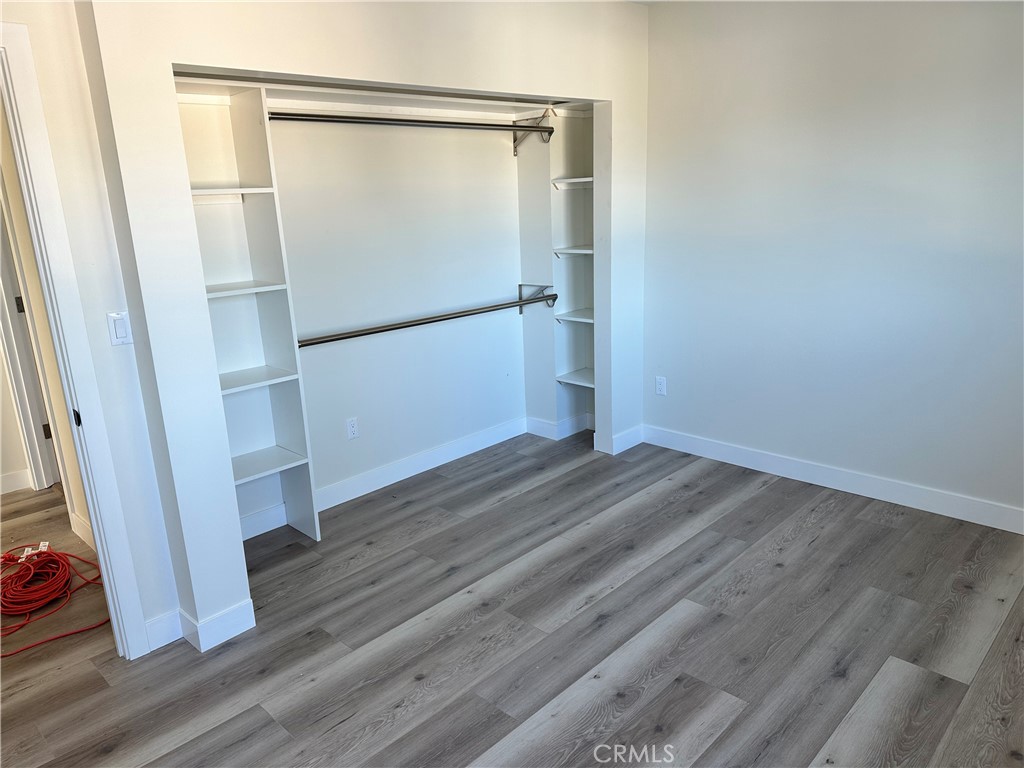 9585 Woodale Avenue Arleta, CA 91331 - Photo 9 of 21 a view of empty room with wooden floor