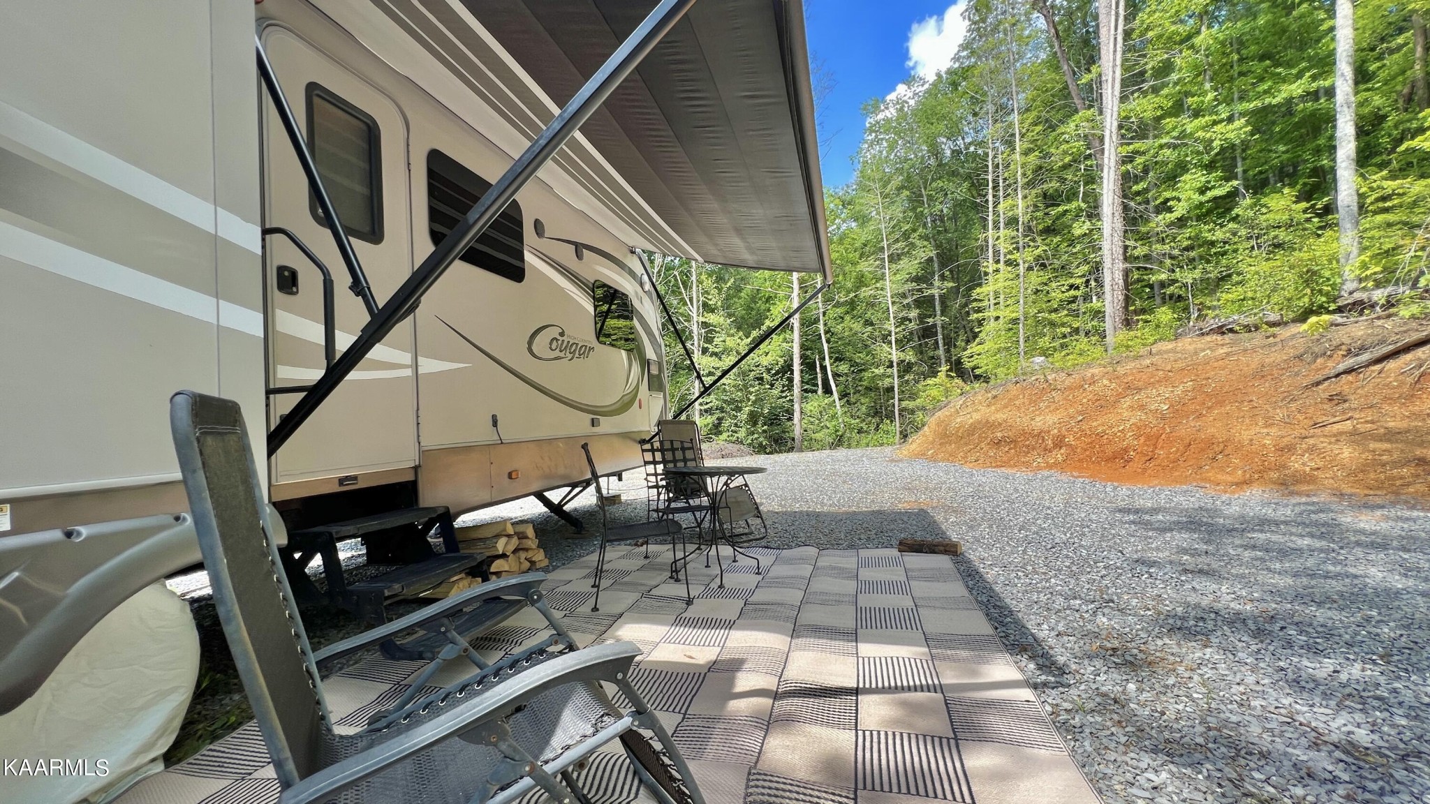 4965 Jones Cove Road Cosby, TN 37722 - Photo 30 of 50 a backyard of a house with table and chairs
