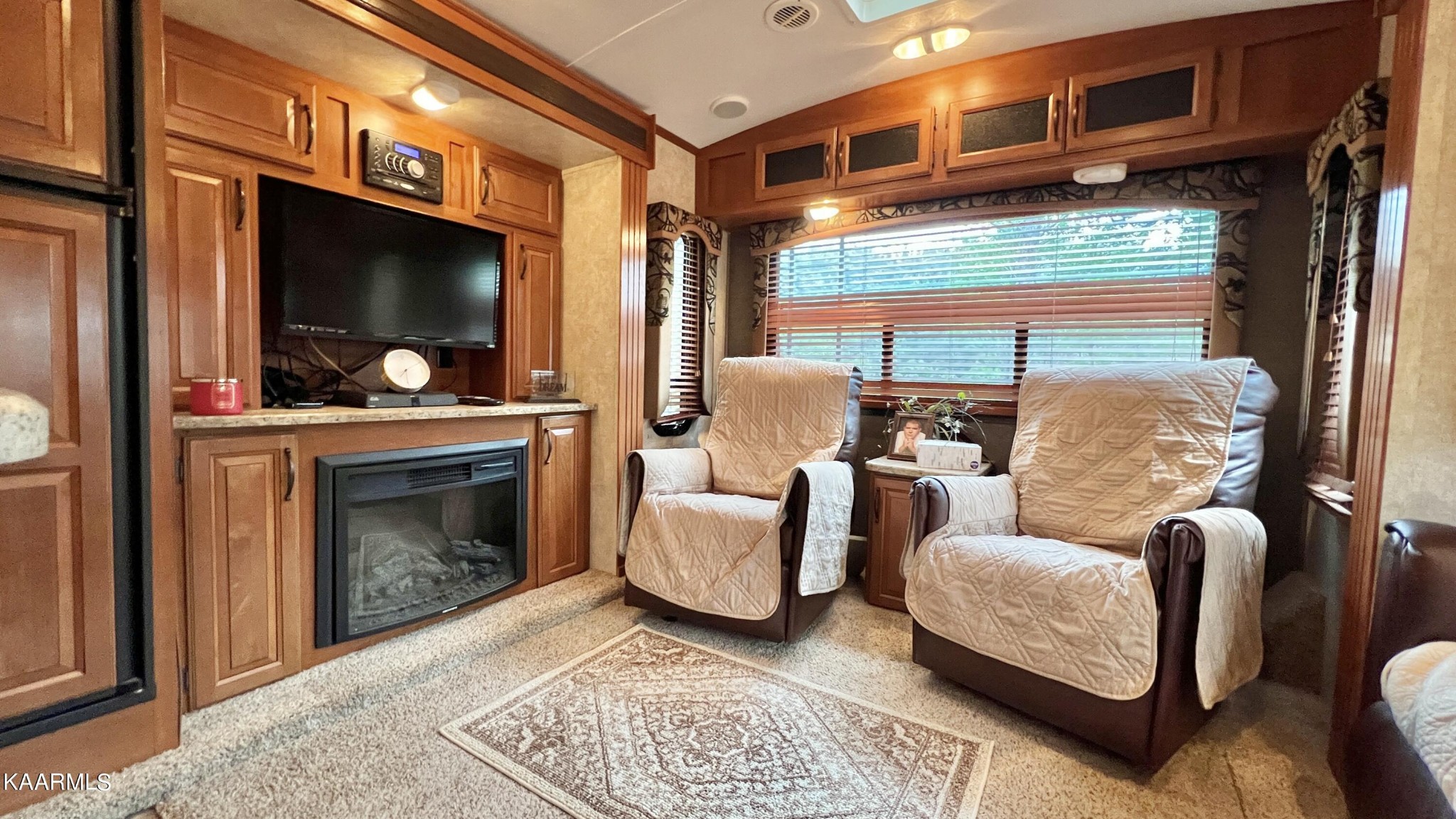 4965 Jones Cove Road Cosby, TN 37722 - Photo 42 of 50 a living room with furniture a rug and a fireplace