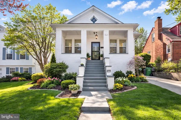 a front view of a house with a garden and plants