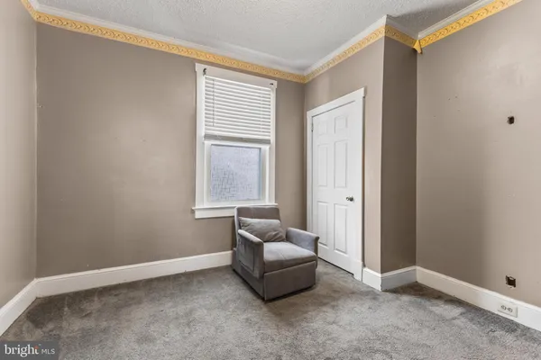 a view of an empty room with cabinet and cabinet