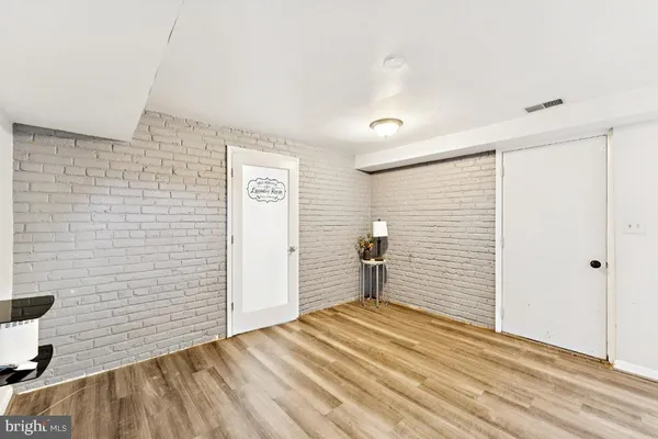 a view of a livingroom with wooden floor and stairs