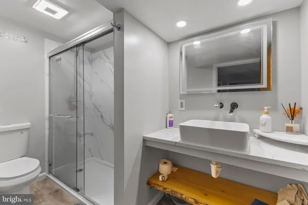 a bathroom with a sink a mirror and a toilet