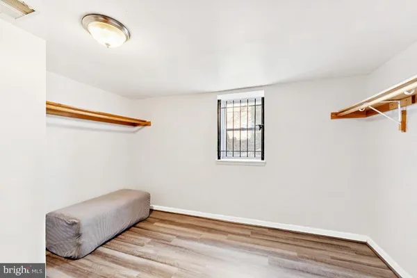 an empty room with a wooden floor and windows