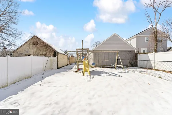 a view of a house with a wooden fence