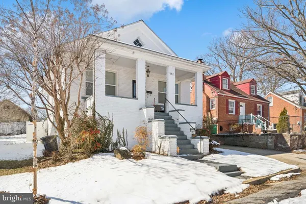 a view of a house with snow on the road