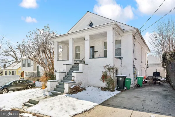 a view of a white house with a snow on the road