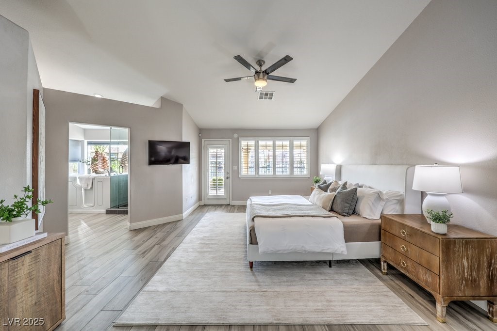 2432 Ocean Front Drive Las Vegas, NV 89128 - Photo 23 of 53 Bedroom featuring access to outside, multiple windows, light wood finished floors, and vaulted ceiling