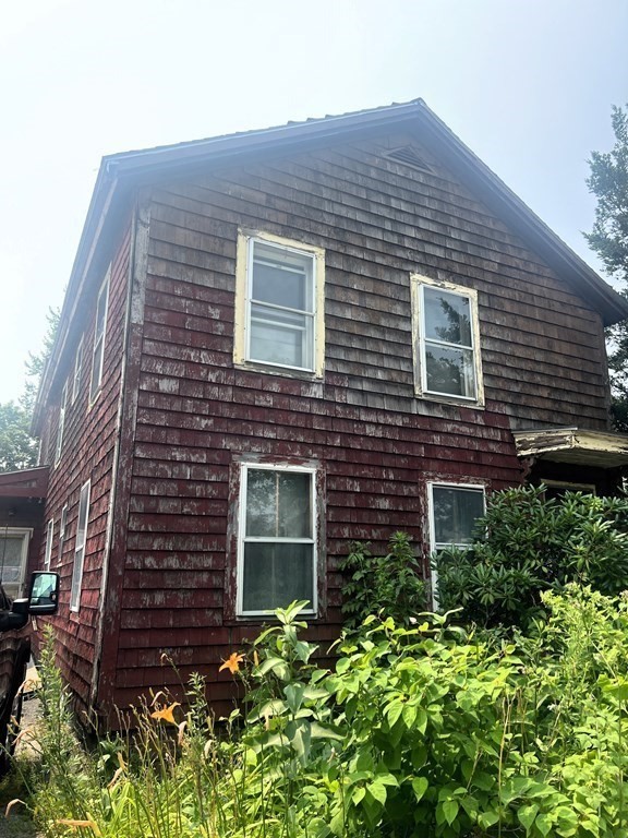 227 Grove Street Worcester, MA 01605 - Photo 6 of 6 a front view of a house with a garden