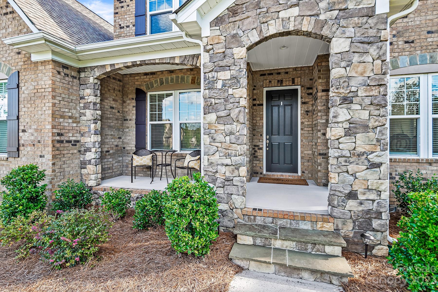 1004 Princessa Drive Wesley Chapel, NC 28104 - Photo 2 of 40 a front view of a house with a garden