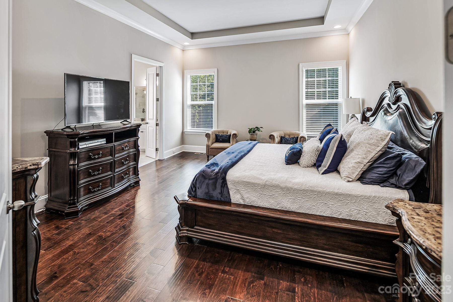 1004 Princessa Drive Wesley Chapel, NC 28104 - Photo 21 of 40 a bedroom with furniture and a flat screen tv