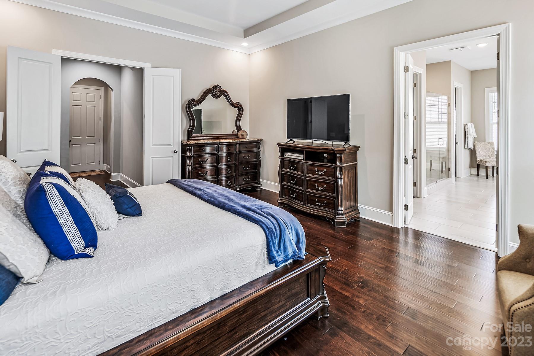 1004 Princessa Drive Wesley Chapel, NC 28104 - Photo 22 of 40 a bedroom with bed and a flat tv screen on a dresser